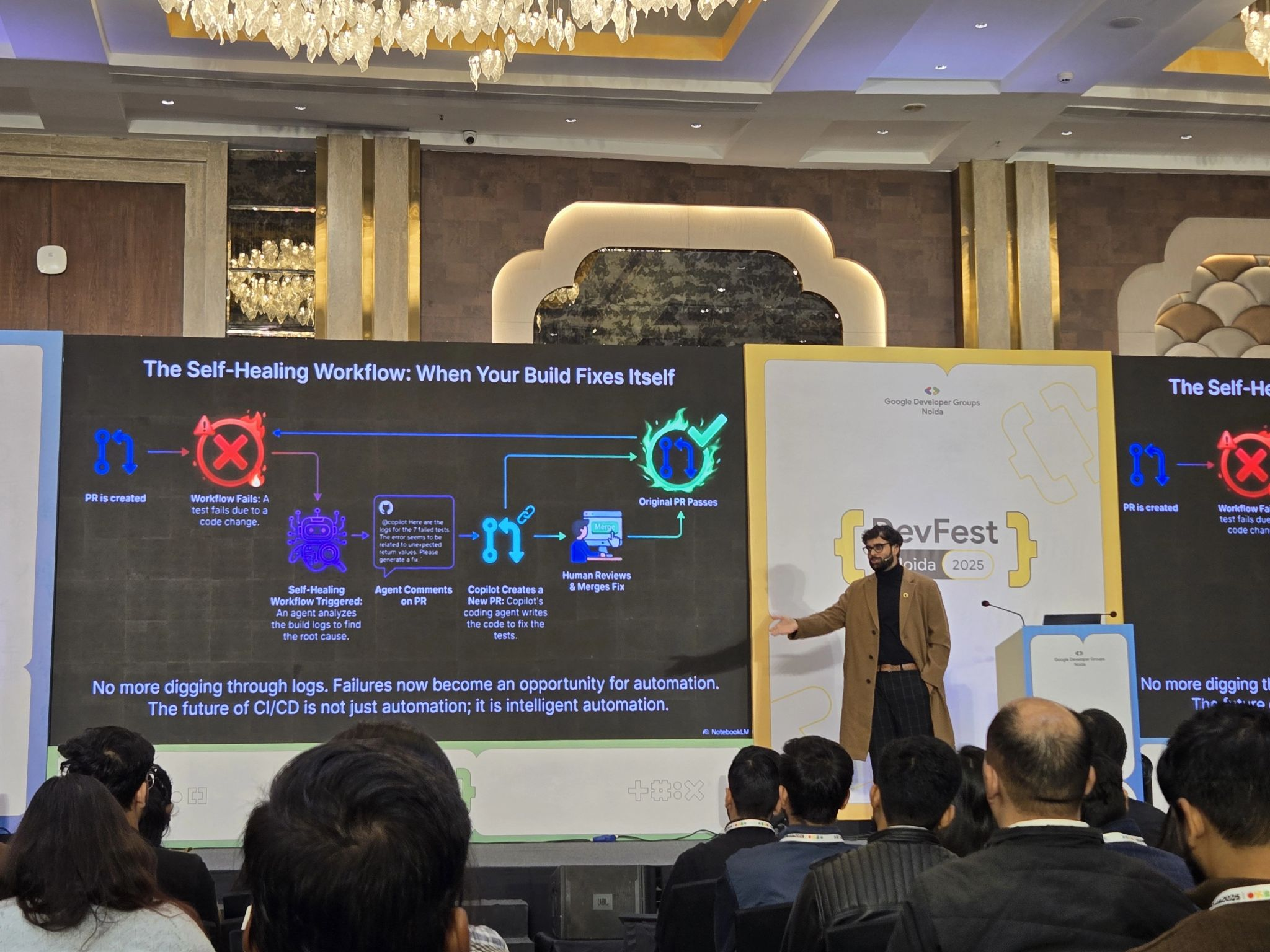 Speaker on stage with slide on screen